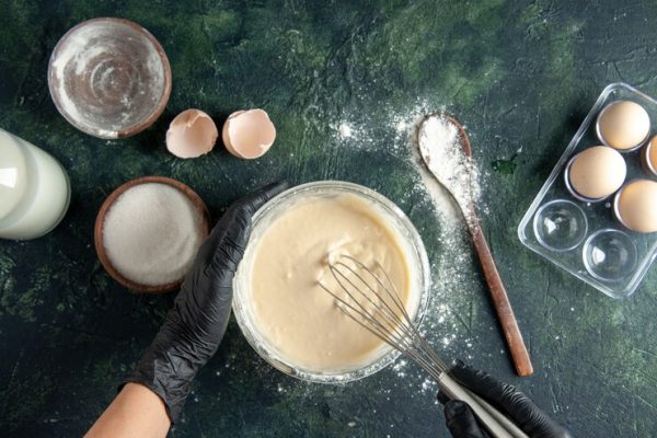 top-view-female-cook-mixing-up-ingredients-making-dough-dark-surface_179666-44579.jpg Basic Baking Essentials Guide